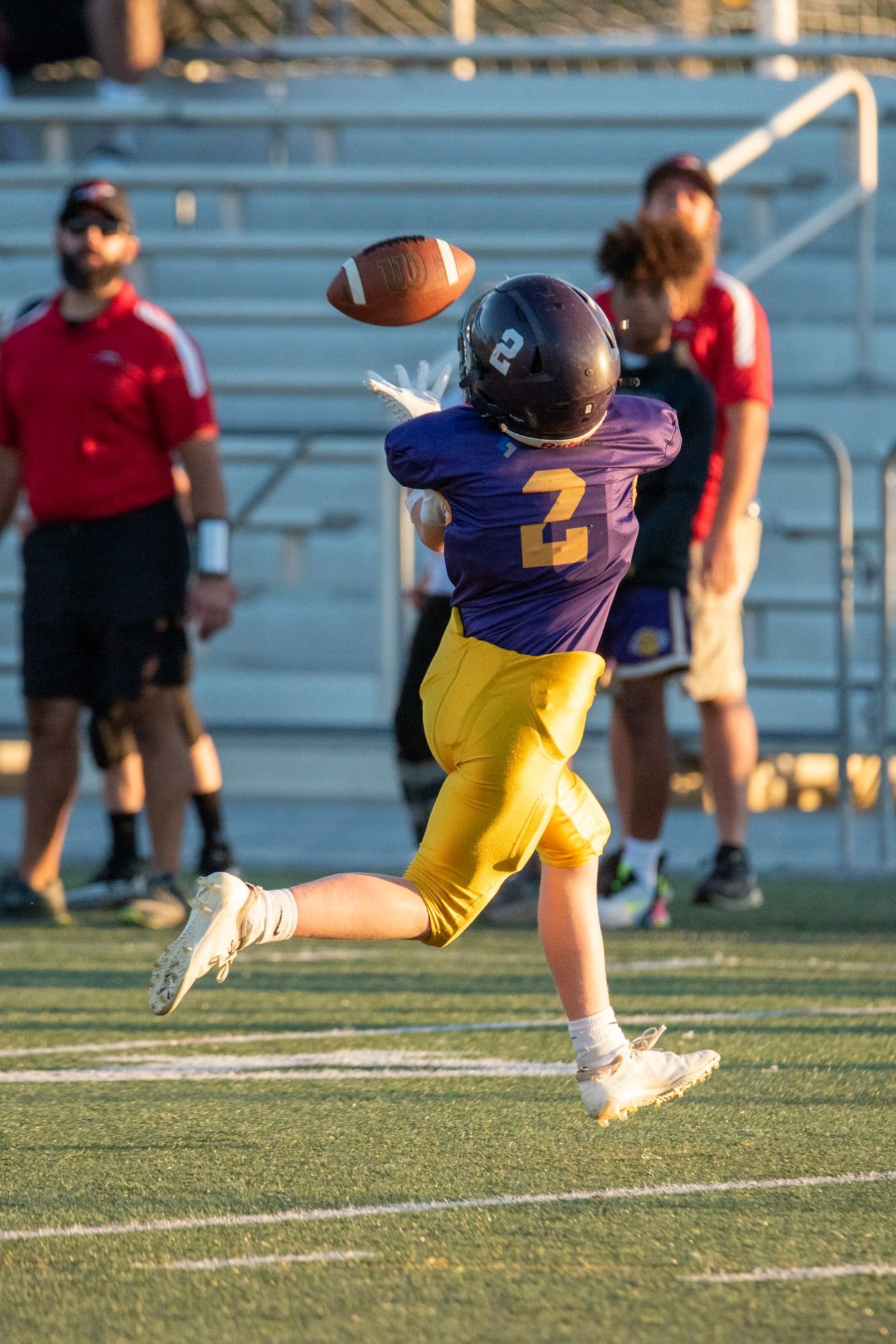 An Ephrata Youth Football player mid-catch downfield during an Ephrata Youth Football game 
