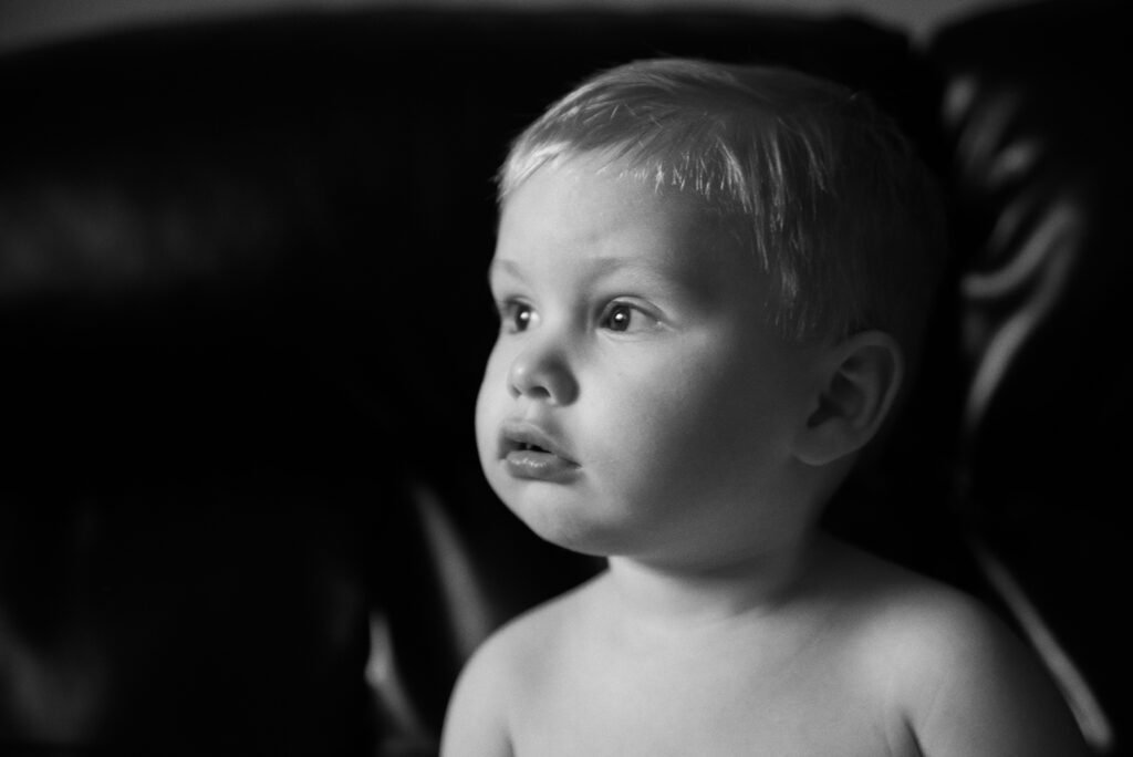 Black-and-white baby portrait photography in Stevens, PA, capturing a curious child.